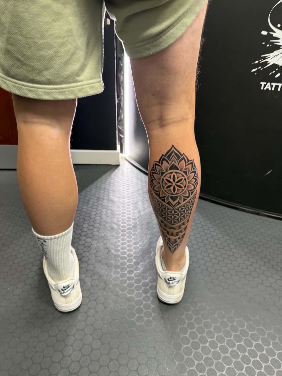 Geometric calf tattoo in black and grey